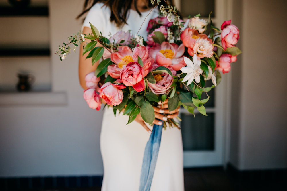 A bride with pink wedding bouquet