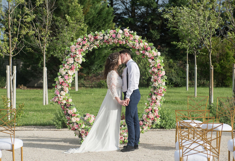 A bride and groom kissing in a private wedding ceremony