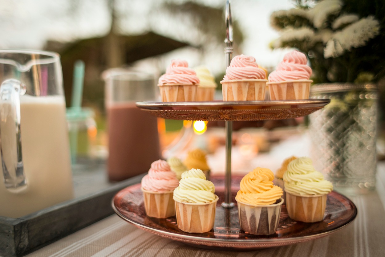 A stack of delicious wedding cupcakes at a wedding reception A stack of delicious wedding cupcakes at a wedding reception