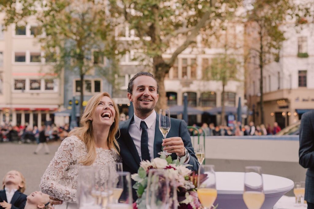 A bride and groom laughing on their wedding day