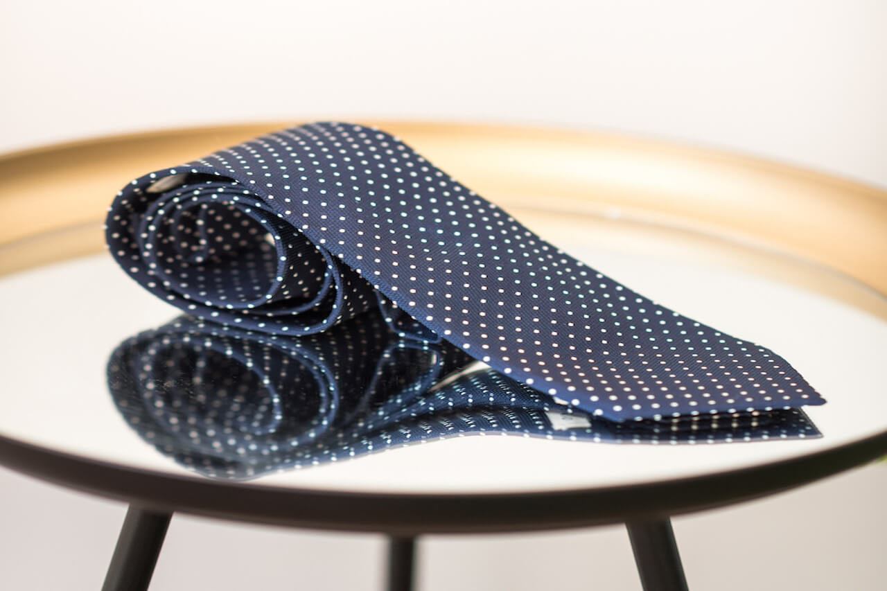 A tie on a mirrored table A tie on a mirrored table