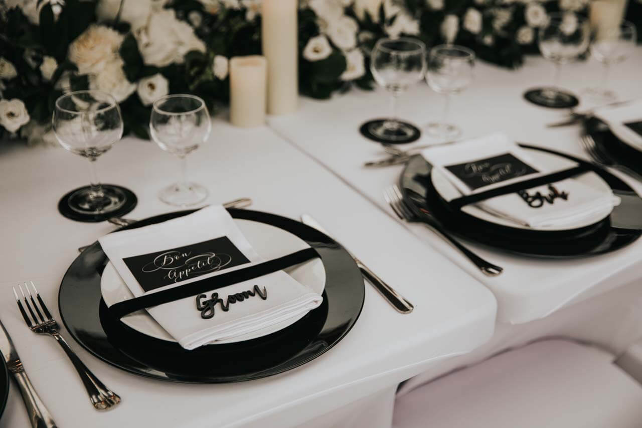 Black and white place settings for a wedding