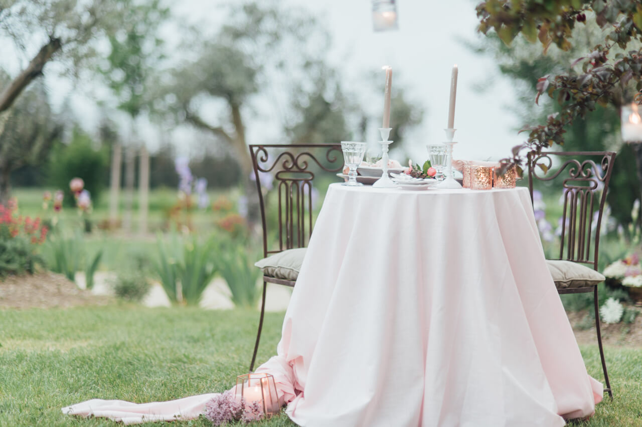 A table in a garden set for a romantic wedding