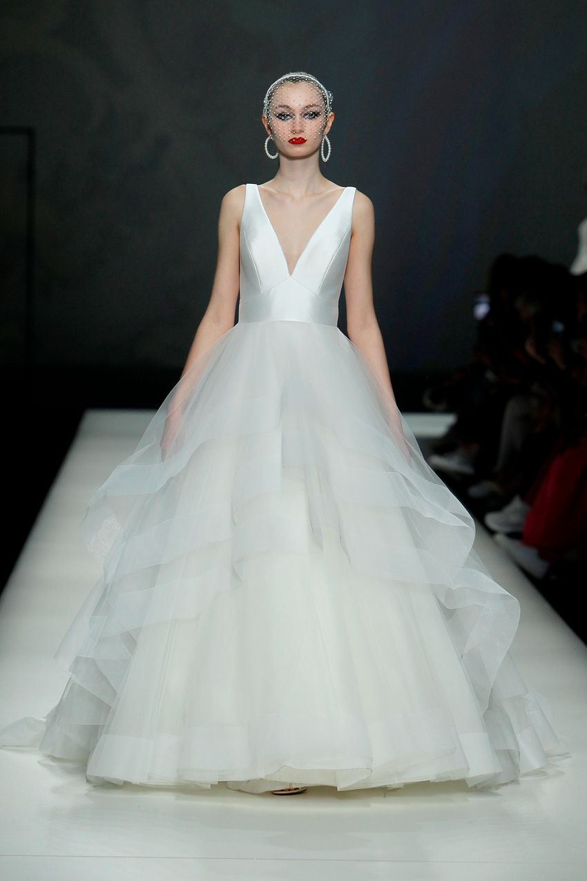 A long white satin ruffle gown by Modeca at the Barcelona Bridal Fashion Week 2022 1